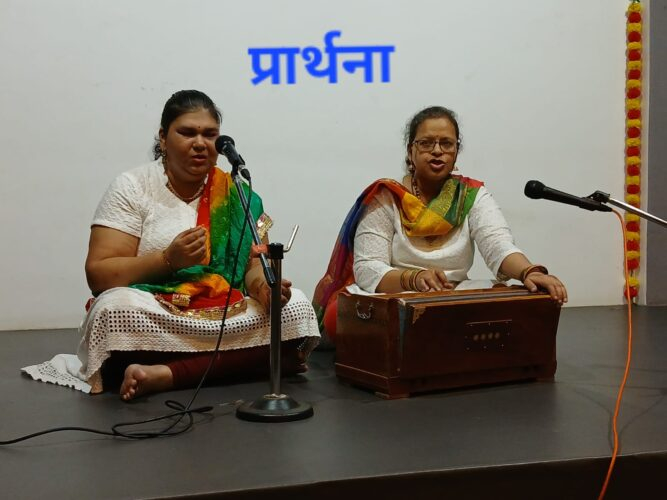 प्रार्थना (Prayer) – Participants performing the opening prayer with harmonium accompaniment during the Mental Health Week Talent Show on 6th October 2026. Two participants performing an opening prayer song accompanied by harmonium during the Mental Health Week Talent Show